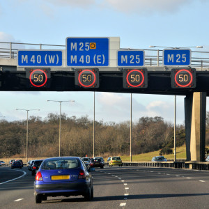 Variable speed limit signs illuminated on M25 motorway near junction with M40